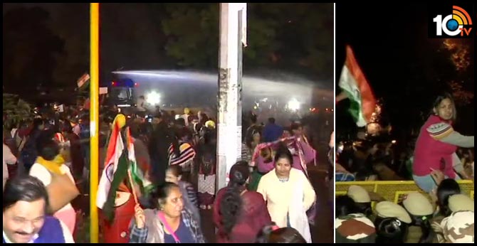 Protesters who are holding a candle march from Raj Ghat to India Gate try to jump barricades