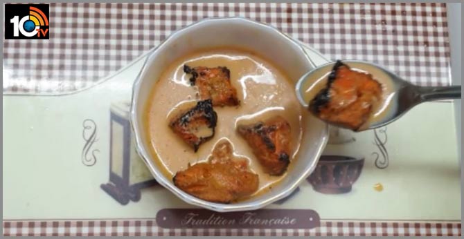 Woman eats Chicken Tikka dipped in Chai