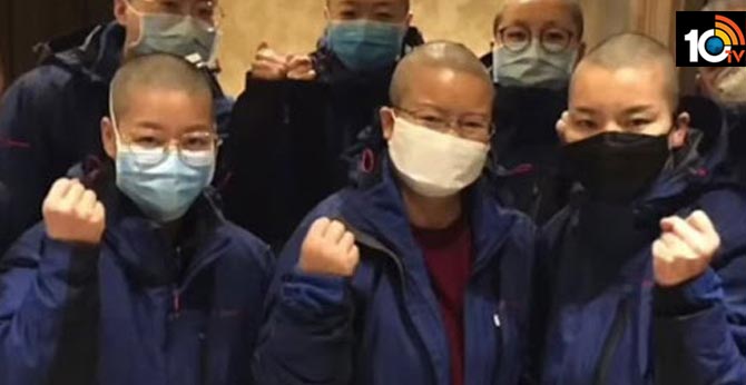 Female nurses shave their hair to prevent cross contamination