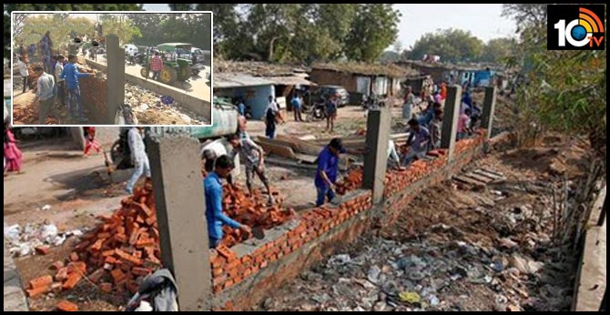 Walls rise in Ahmedabad ahead of Donald Trump visit
