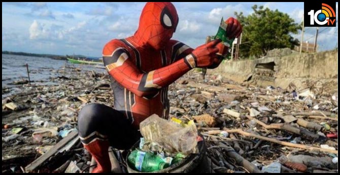 indonesian man dresses up as spider man to clean up trash from streets and beaches