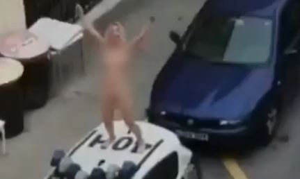 Nude woman hops on cop car after allegedly skirting Spain’s coronavirus restrictions