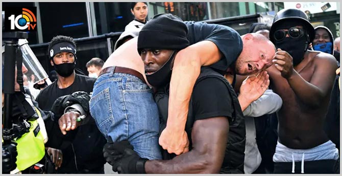 Photo Of Black Man Carrying Injured White Man At London Protests Is Viral