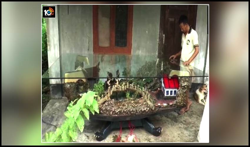 nagaland-sculptor-crafts-beautiful-village-on-a-wooden-table