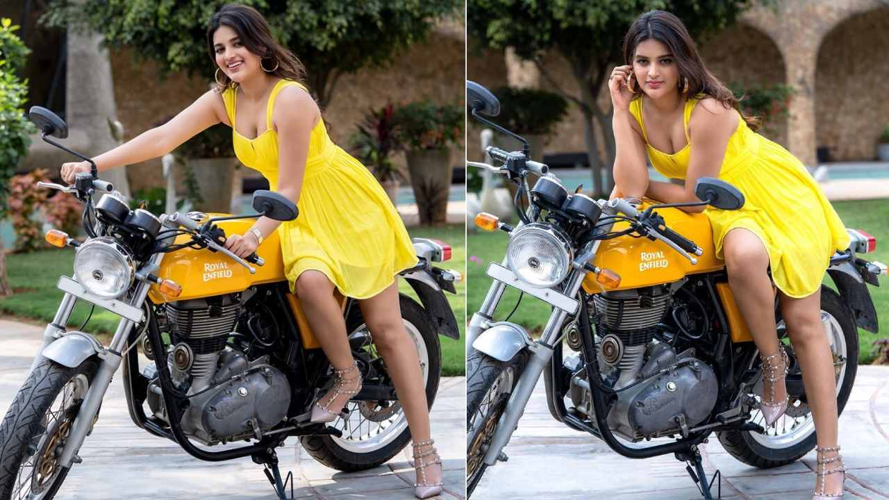 Nidhhi Agerwal Poses On Royal Enfield Bike In Yellow Dress