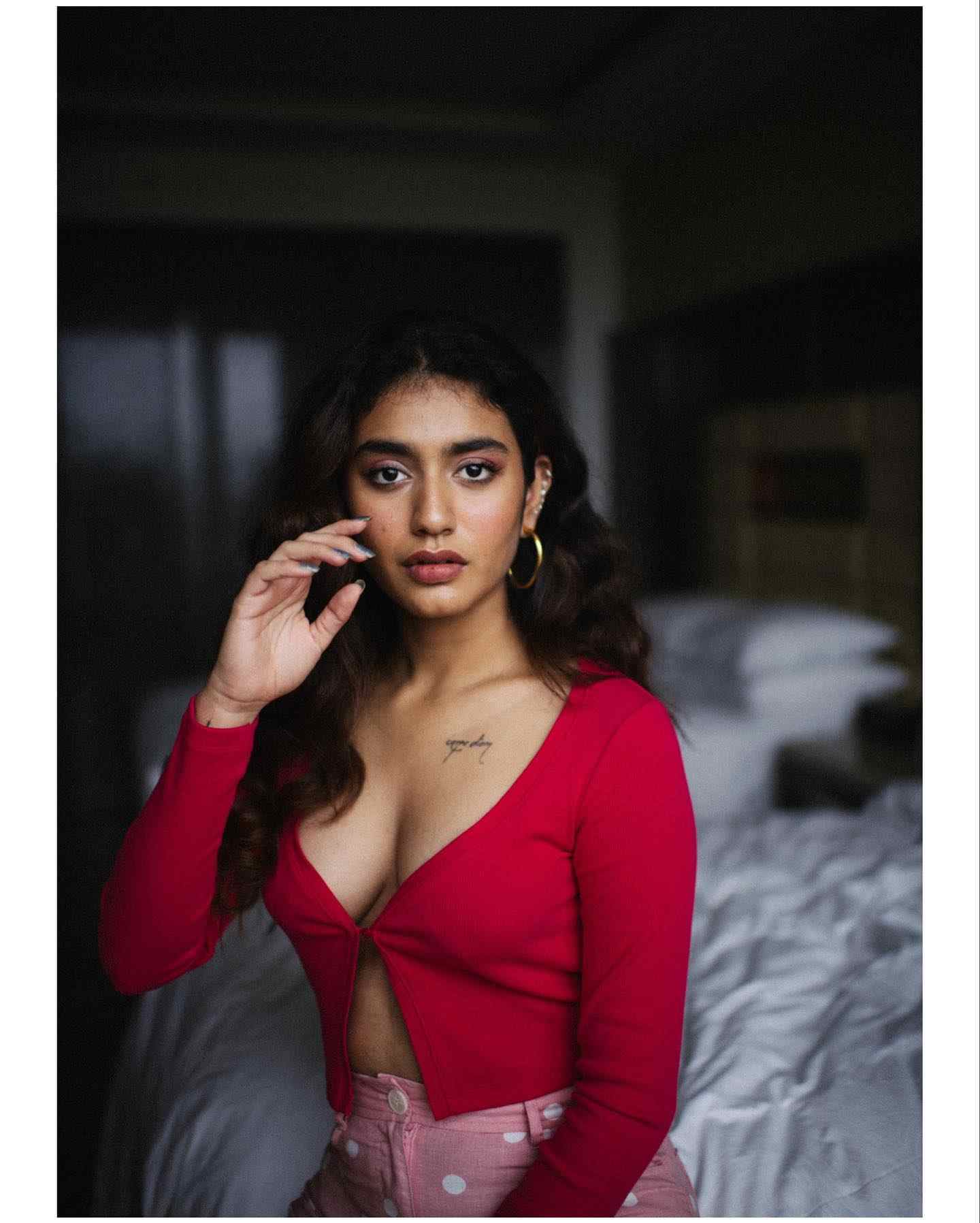 Priya Varrier stunning photos in red dress on bed