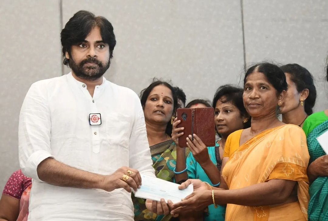 Janasena chief Pawan Kalyan presenting the cheques