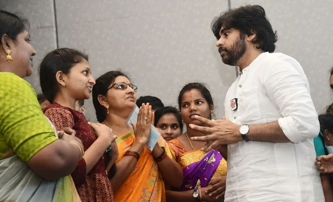 Janasena chief Pawan Kalyan presenting the cheques