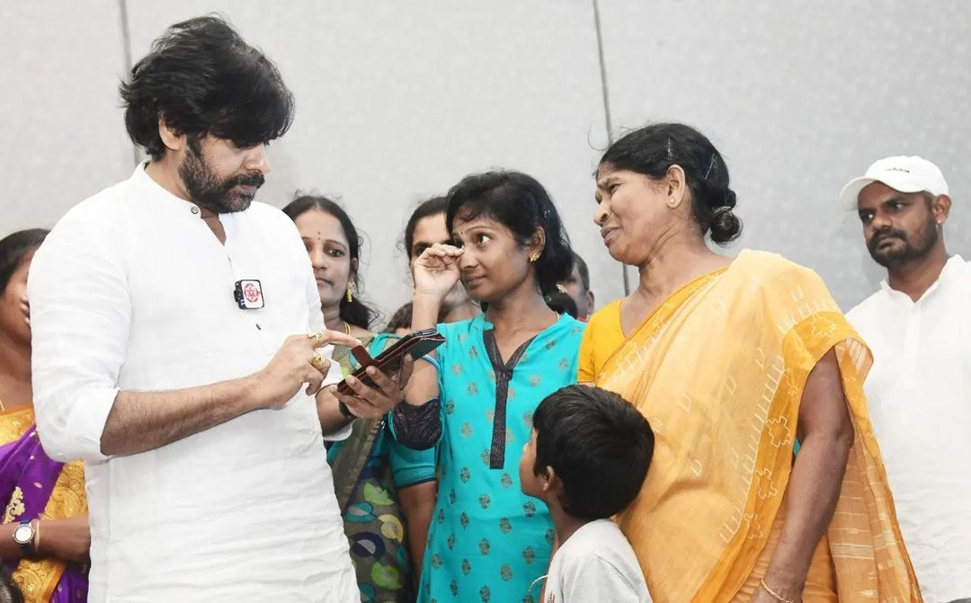 Janasena chief Pawan Kalyan presenting the cheques