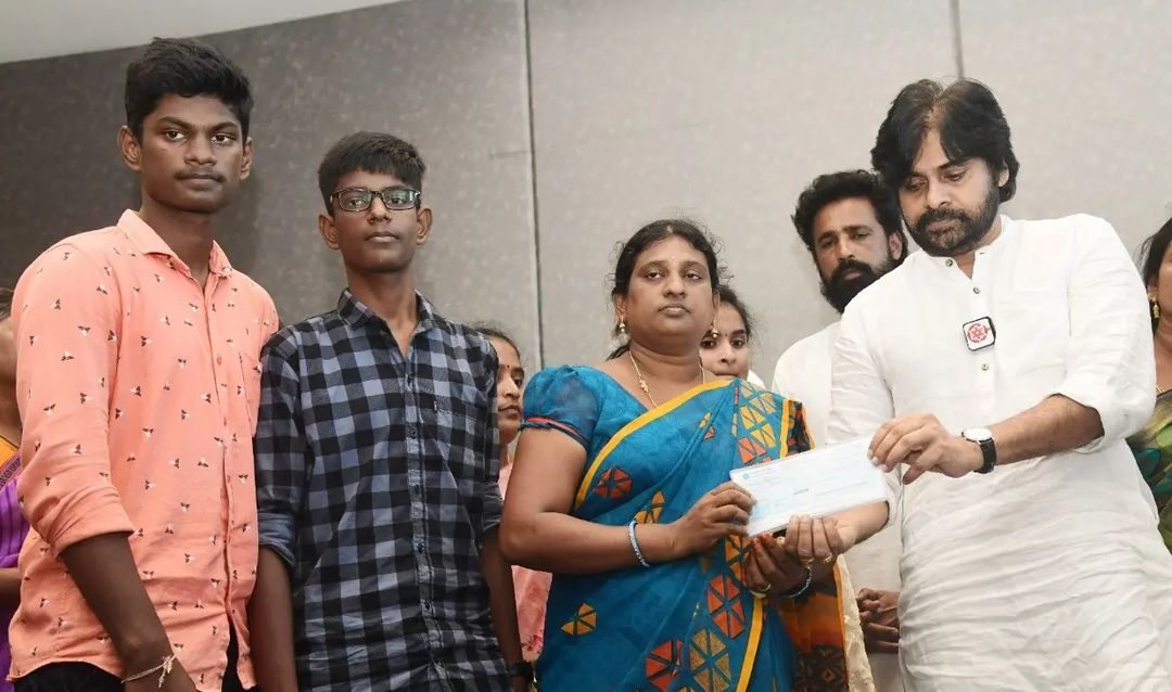 Janasena chief Pawan Kalyan presenting the cheques