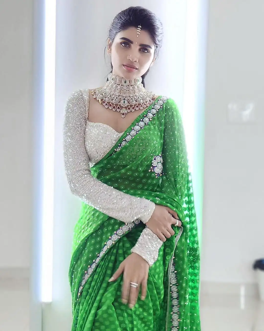 Varsha is sparkling with a necklace around her neck