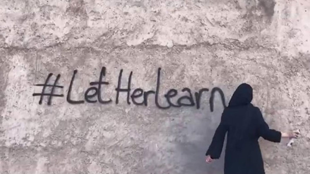 Afghan girls paint on wall ‘Let her learn’ to protest over university ban