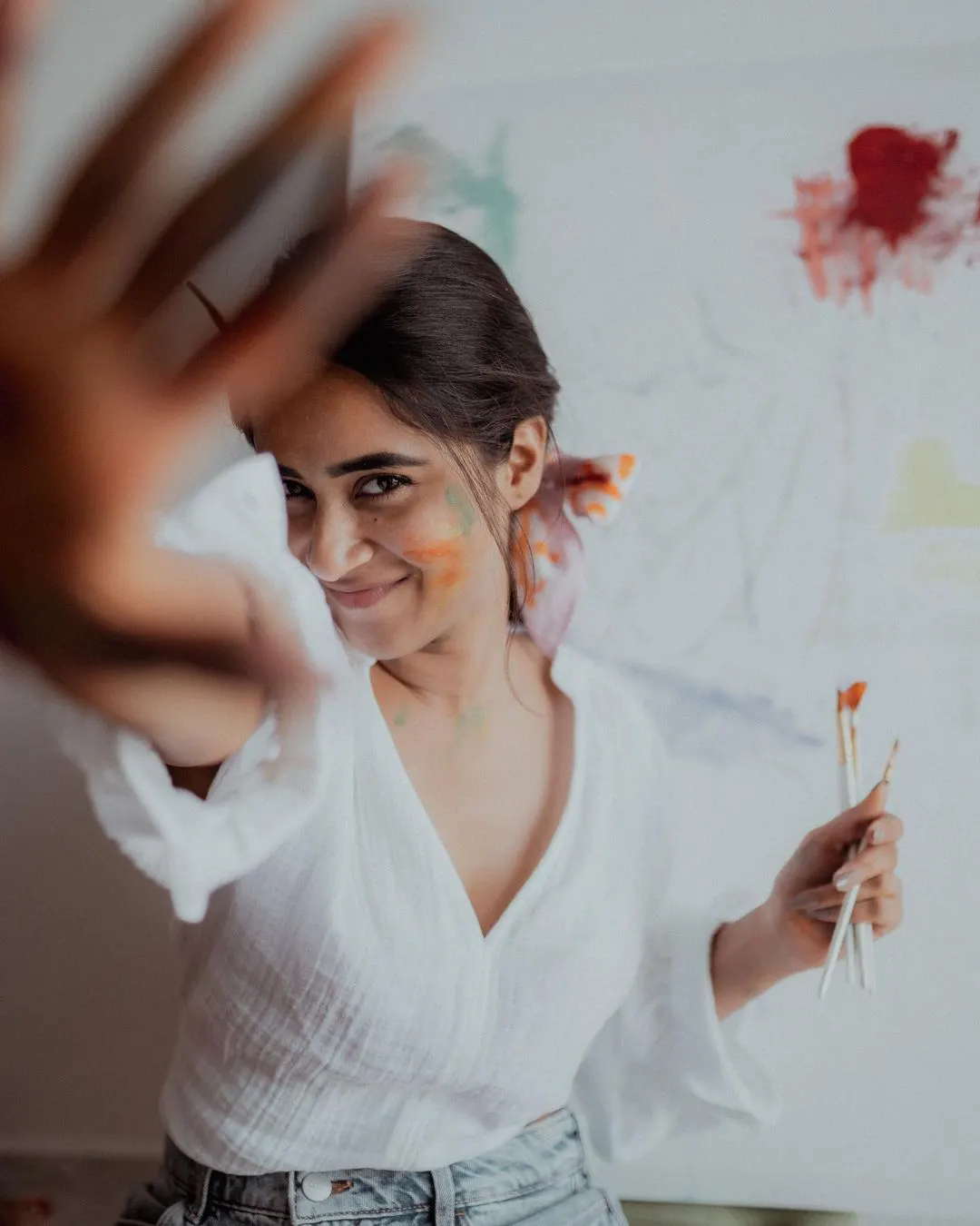 Deepti Sunaina posing for fun while painting