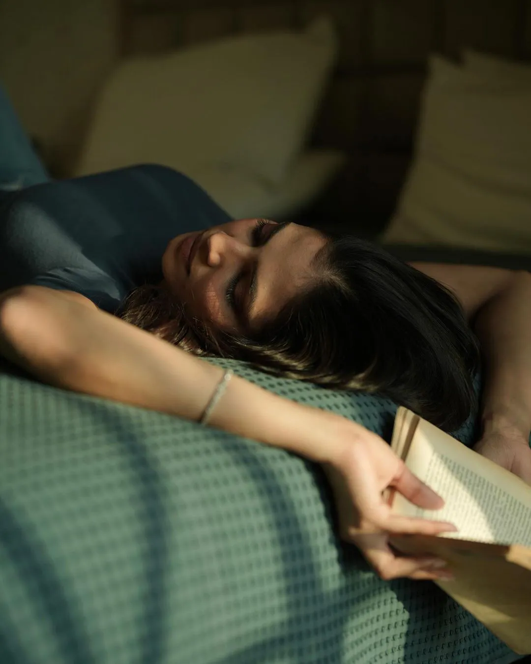 Malavika Mohanan Stills with Reading Book on Bed