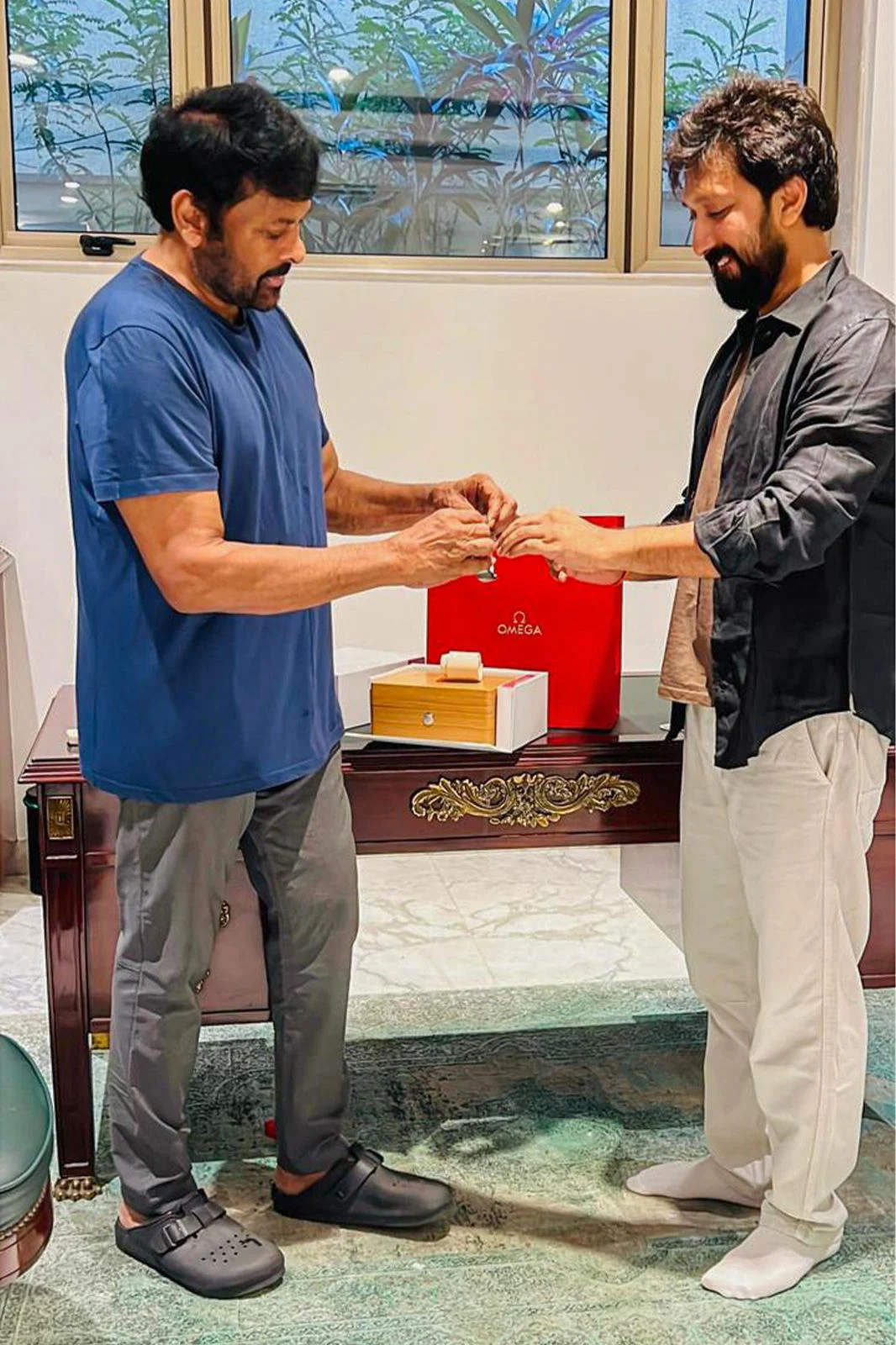 Chiranjeevi Gifterd Watch to Director Bobby