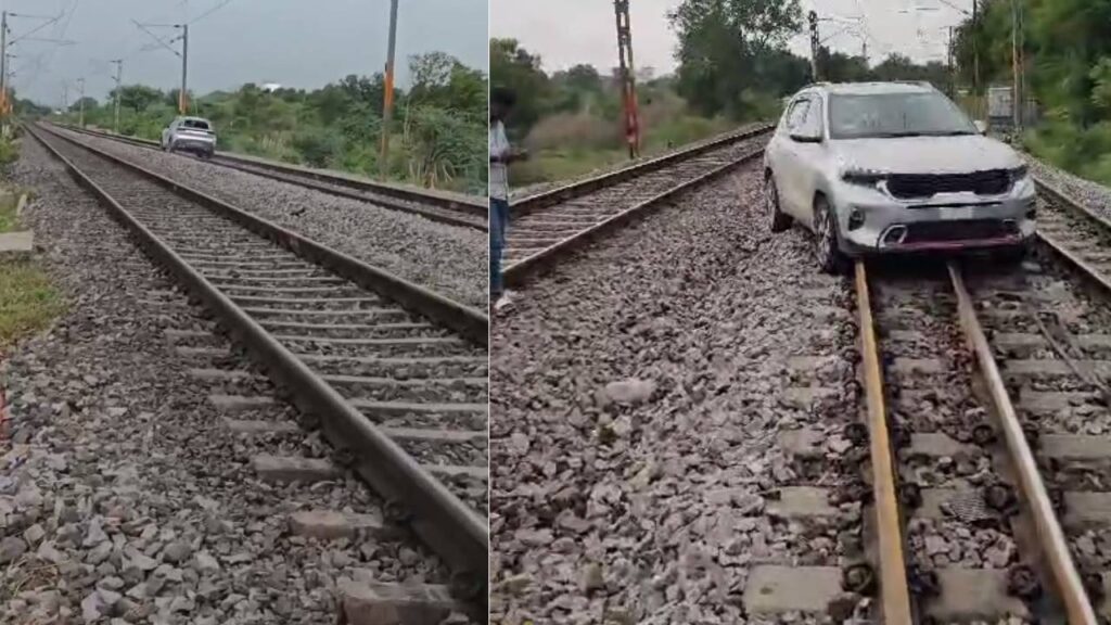 Young Woman Drives Car on Railway Track